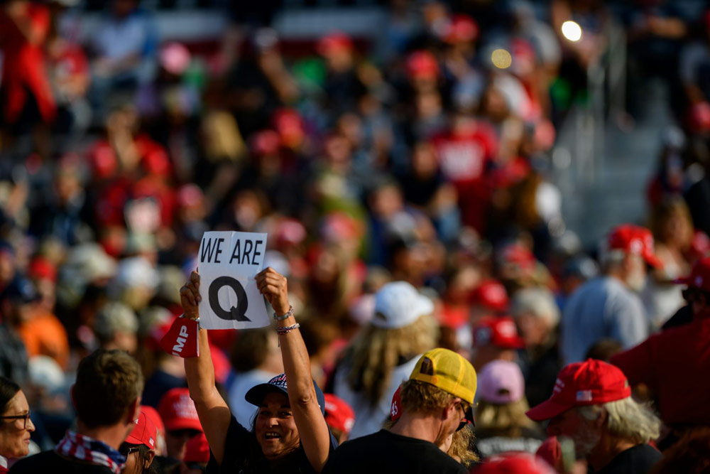 QAnon supporters wait for Donald Trump to speak at a campaign rally at Atlantic Aviation on September 22, 2020, in Moon Township, Pennsylvania.