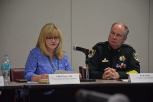 The Sheriff's Office's Becky Quintieri, briefing the panel on conditions at the jail, and Sheriff Rick Staly this morning. (© FlaglerLive)