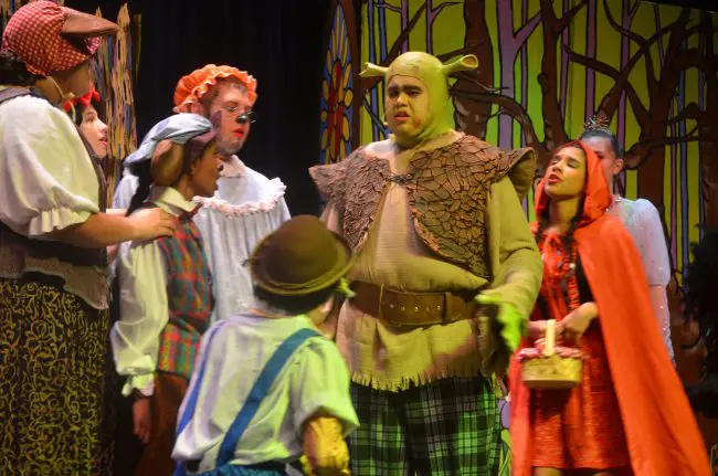 Shrek (Rafael Soto) is displeased with freaks invading his swamp as 'Shrek the Musical' begins: the big production opens at Matanzas High School's Pirate Theater with a  show for friends and family Wednesday and general public admission Thursday through Saturday. Click on the image for larger view. (© FlaglerLive)