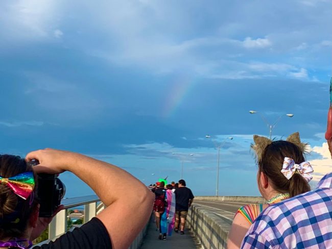 An actual rainbow briefly refracted from the marchers as they walked over the bridge. (© FlaglerLive)