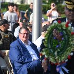 U.S. Rep. Randy Fine, left, as Palm Coast Council member Charles Gambaro would ceremonially place a wreath near a monument during Monday's Memorial Day commemoration at Heroes Park. (© FlaglerLive)