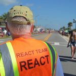 A traffic volunteer at a Flagler Beach July 4 celebration, just before the city's Independence Day parade. (© FlaglerLive)