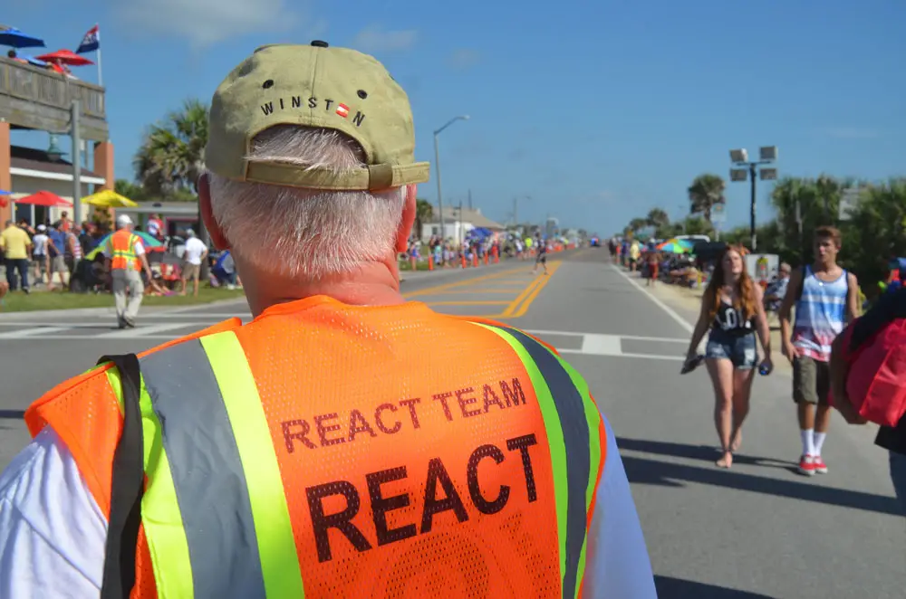 A traffic volunteer at a Flagler Beach July 4 celebration, just before the city's Independence Day parade. (© FlaglerLive)
