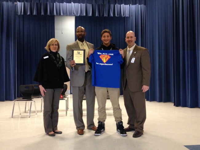 Tyler Irogoyen today after his recognition, with, from left, School Board member Janet McDonald, Buddy Taylor Principal Stephen Hinson, and Superintendent Jacob Oliva. Click on the image for larger view. 