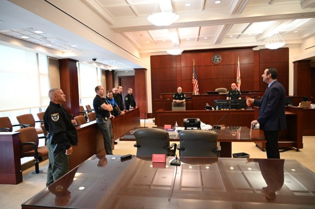 The recruits in the jury box, with Sgt. Daniel Weaver, second from left, and Assistant State Attorney Jason Lewis, right. (© FlaglerLive)