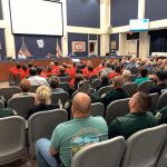 The red and the green--firefighters and cops--filled the county commission's chamber at a meeting this afternoon. (© FlaglerLive)