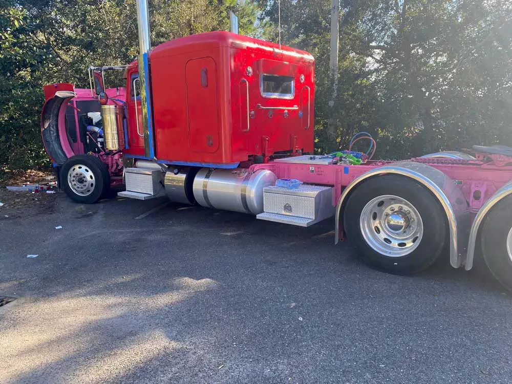 The truck that had been reported stolen was in a corner of the parking lot at Palm Coast's Days Inn, where two suspects were spray-painting it scarlet red, making it, ironically, that much more conspicuous. A witness saw the spray-painting and called in to the Sheriff's Office. (FCSO)