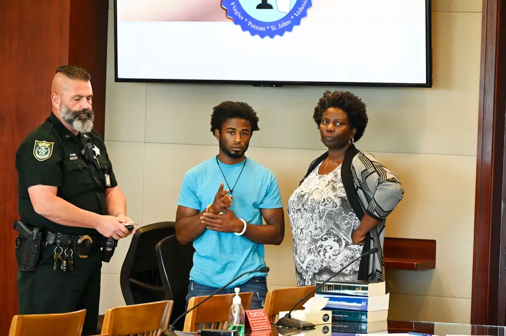L'Darius Smith after the verdict with his attorney, Assistant Public Defender Regina Nunnally, and Greg Weston, a sheriff's deputy. (© FlaglerLive)