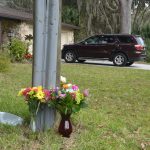 A roadside memorial for Logan Goodman went up soon after he was killed in a motorcycle crash last January in Palm Coast's Woodlands. (© FlaglerLive)