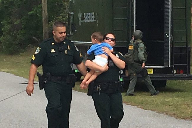 An image the sheriff's office released this afternoon of the rescue of the 2-year-old boy, who was not harmed, in the course of a domestic violence issue involving his parents on Parkview Drive this afternoon. (FCSO)