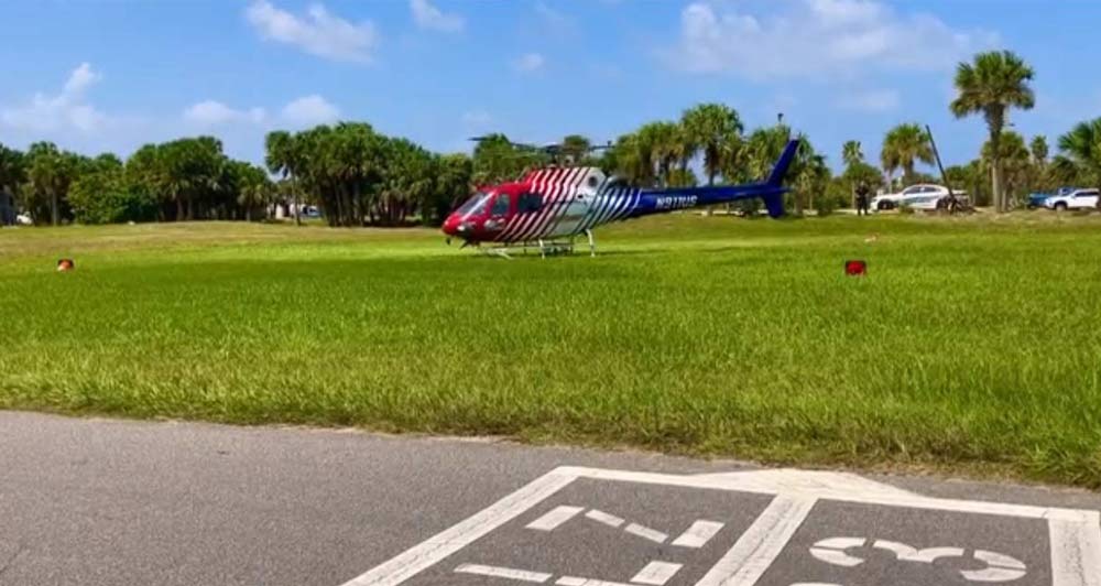 Flagler County FireFlight, the emergency helicopter, taking off from Santa Maria del Mar Catholic Church after taking aboard the person who had jumped off the Flagler Beach bridge, and before flying to Halifax hospital. (© FlaglerLive via Flagler Beach Police video),