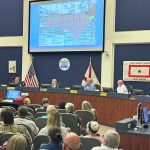 A map of the proposed 8,000-home Reserve at Haw Creek looms over the Bunnell City Commission Monday evening, before the vote that killed the development. (© FlaglerLive)