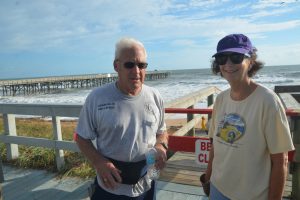 Barbara Revels with Flagler Beach Commissioner Marshal Shupe during a beach clean-up. (© FlaglerLive)