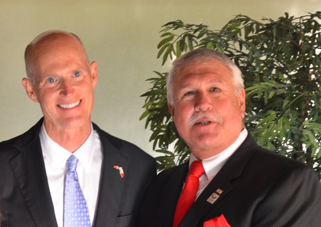 They'll get to do it again next week: Gov. Rick Scott with Frank Meeker, now the chairman of the Flagler County Commission, at a local Republican dinner two years ago. (© FlaglerLive)