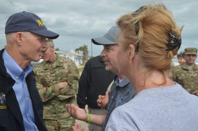 Flagler Superintendent Jacob Oliva, center, speaking with Gov. Rick Scott, with School Board member Colleen Conklin, last October in Flagler Beach. The school board is asking the governor to veto a massive education bill the Flagler district, like many across the state considers damaging to the system. (© FlaglerLive)