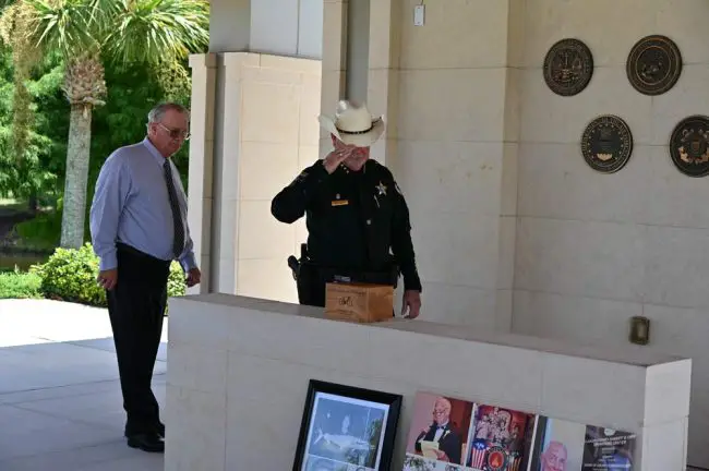 Sheriff Rick Staly and Flagler Beach Commissioner Rick Belhumeur paying their final respects. (© FlaglerLive)