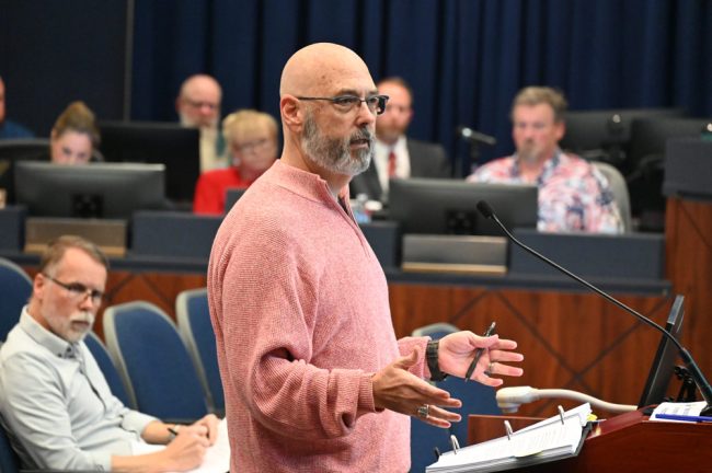 Bunnell resident Larry Rogers addressing the City Commission on Monday. Chad Grimm, the developer's representative, is to the left. (© FlaglerLive)