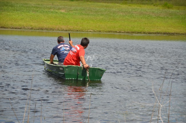 Roger's Towing crew had to row to the submerged SUV to hook its lines. Click on the image for larger view. (© FlaglerLive)