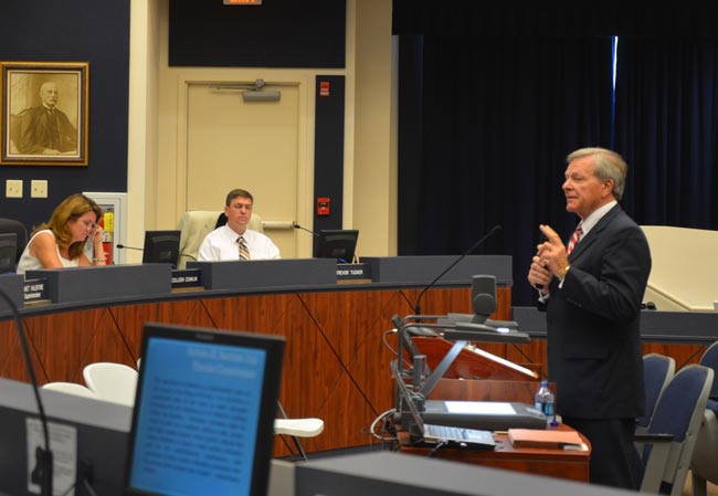 Ronald Meyer, right, an attorney, has been challenging imbalances in the state's educational system for years. He was invited to address the board by Colleen Conklin, left. Trevor Tucker is at center. (FlaglerLive)