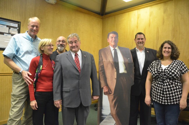 The candidates, flanking a cardboard cut-out of Ronald Reagan. From left, with their race in parenthesis: Dennis McDonald (County Commission), Janet McDonald (Schoolo Board), Steve Nobile (Palm Coast City Council), Michael McElroy (School Board), Mark Richter (County Commission) and Anne-Marie Shaffer (Palm Coast City Council). Click on the image for larger view. (© FlaglerLive)