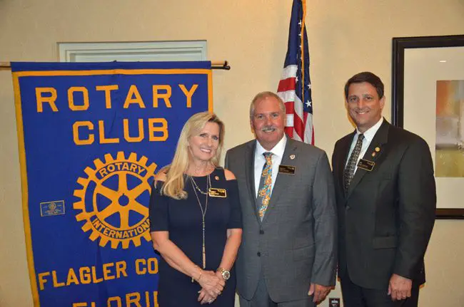 The Flagler County Rotary Club Thursday evening held its installation banquet as now Past-President Jim Troiano's tenure came to an end, and that of Tracy Loftus, center, began. Cindy Kiel Evans is president-elect. The Rotary provided $12,000 in scholarships under Troiano's tenure, and is putting renewed emphasis on membership and fund-raising this year, as with a gala that will precede the annual opening of its popular Fantasy Lights at Town Center's Central Park in the run-up to Christmas and New Year's. Troiano, who had been part of former Sheriff Jim Manfre's administration, is now the intergovernmental coordinator for the St. Johns River Water Management District, which includes Flagler County. Loftus is with Tom Gibbs Chevrolet, and Kiel Evans is with State Farms. (© FlaglerLive)