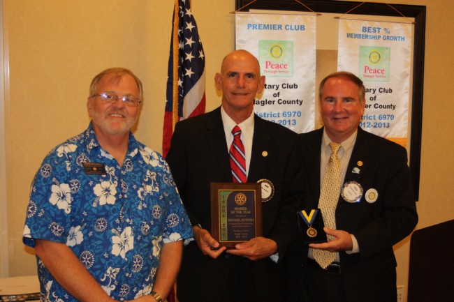 Rotarian Mike Kuypers, center, received the Rotarian of the Year Award from District Governor John Brunner and President Staly. Click on the image for larger view. (Rotary Club)