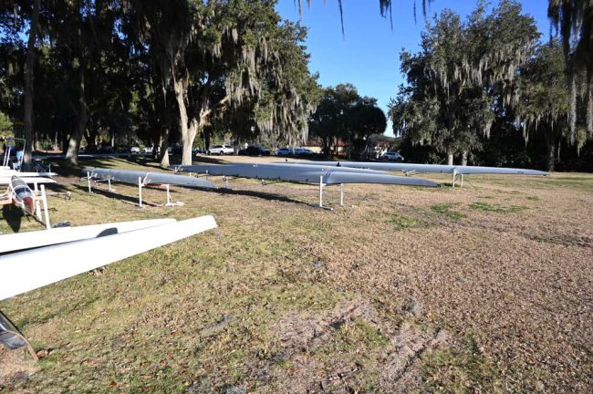 The Palm Coast Rowing Club's canoes in back of the Green Lion, where water is used regularly to hose down the canoes, Tony Marlow says. (© FlaglerLive)