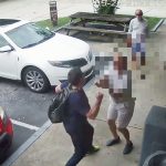 Sean Ruel, 39, seen about to punch a 76-year-old man outside a convenience store in Palm Coast on May 22 in a still from surveillance camera footage released by the Sheriff's Office. (© FlaglerLive via YouTube)