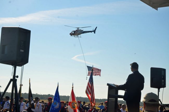 Sal Rutigliano, Flagler County Veterans Services Officer, watches a fly-by of Flagler County FireFlight on what was Rutigliano's last day on the job. Click on the image for larger view. (© FlaglerLive)