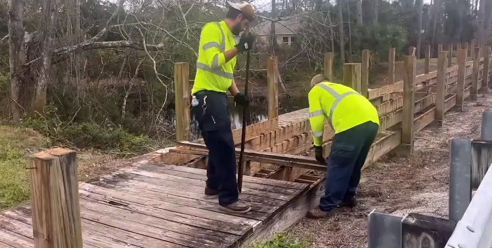 Crews working on one of the Rymfire bridges. (© FlaglerLive via Palm Coast video)