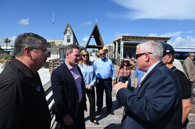 Jorge Salinas, center, with local officials during a visit at the Flagler Beach pier with then-House Rep. Mike Waltz, in August 2024. (© FlaglerLive)