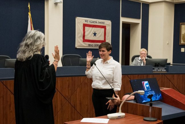 Sally Hunt is sworn in as the soon-to-be Chair Cheryl Massaro looks on. (Flagler Schools)