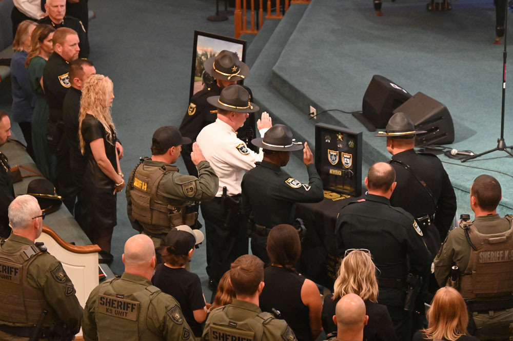 Saluting the remains. (© FlaglerLive)