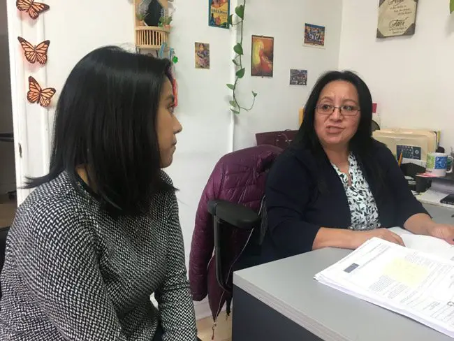 Erendira Rendon, national projects director with The Resurrection Project in Chicago, goes over the influx of questions from local residents with Guadalupe Raymundo, who represents undocumented immigrants in their deportation appeals. The Project has been briefing fearful immigrants ahead of Donald Trump's order cracking down on sanctuary cities. (Tanla Karas, IRIN)