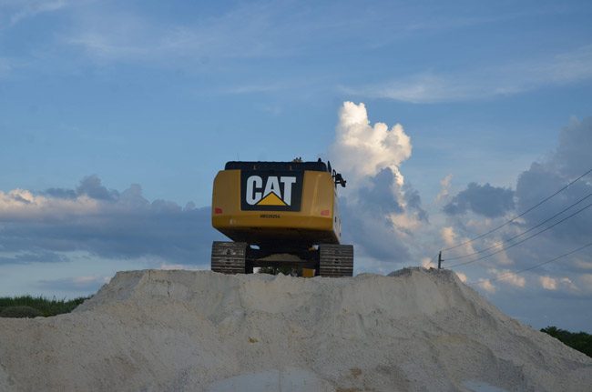 Sand brought in from Gainesville is dumped on this pile, then reloaded for dune-building. (© FlaglerLive)