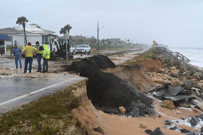 Emergency sand was getting dumped near 12th Street South during the storm this morning. (© FlaglerLive)