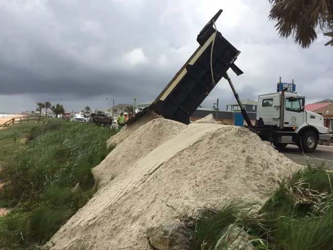 The Florida Department of Transportation has been dumping emergency sand berms along the north end of Flagler Beach in anticipation of a storm surge. Flagler County Public Works crews have been doing likewise at several locations in the Hammock, and the Department of Environmental Protection is building big berms at Washington Oaks Garden State Park, an area that Hurricane Matthew severely breached last October, leading to deep flooding of the island. (© FlaglerLive)