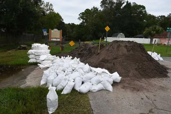 The sandbag station, now self-serve, after city crews and inmates filled bags for several hours for Woodlands residents to take at will today. (© FlaglerLive)