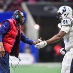 Jackson State Tigers coach Deion Sanders greets right tackle Deontae Graham during the Cricket Celebration Bowl on Dec. 17, 2022. (Austin McAfee/Icon Sportswire via Getty Images)