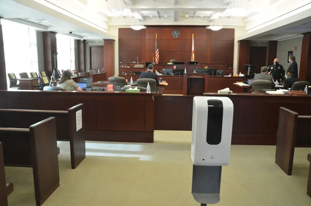 A hand sanitizer at a courtroom in Bunnell. masking requirements in the court remain in place. (© FlaglerLive)