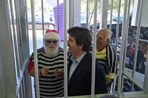 Rick Giumenta, the prison stripes covering his famed Santa garb, with his attorney, Michael Chiumento III, who was jailed without a warrant. Click on the image for larger view. (© FlaglerLive)