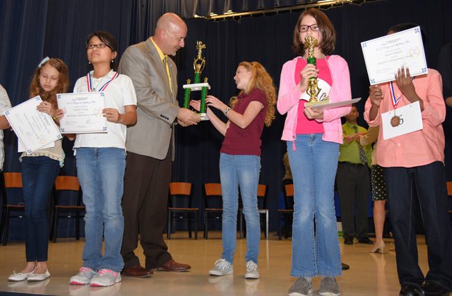 Sarah Flannery accepts her trophy from Superintendent Jacob Oliva. (Jason Wheeler, Flagler Schools)