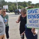 Captain's co-owner Chris Herrera, left, speaking with protesters in November 2018, days after the county commission had approved a lease agreement with the restaurant, and days before it would reconsider it. (© FlaglerLive)