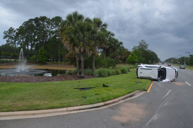 The Equinox in relation to the Caravan, only the top of which was visible in the pond. Initially, the Caravan's cab was higher than the water level. Click on the image for larger view. (© FlaglerLive)