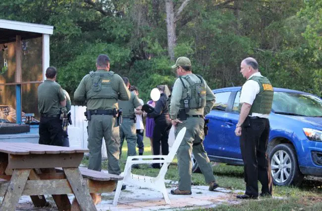 The scene at 80 Pine Tree Lane in the Mondex this morning, where law enforcement authorities served a search warrant and later found a body. Sheriff Rick Staly is to the right. (FCSO)