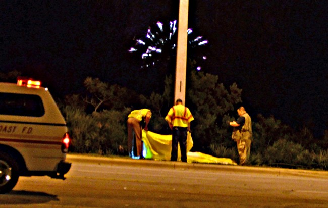 A Florida Highway Patrol investigator, the medical examiner and the Palm Coast Fire Police captain at the scene of this evening's motorcycle fatality, across from Belle Terre Elementary. (c FlaglerLive)