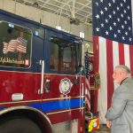 John Schmidt Jr. unveils the name of his son, Marine Lance Corporal John T. Schmidt III on Fire Engine 21