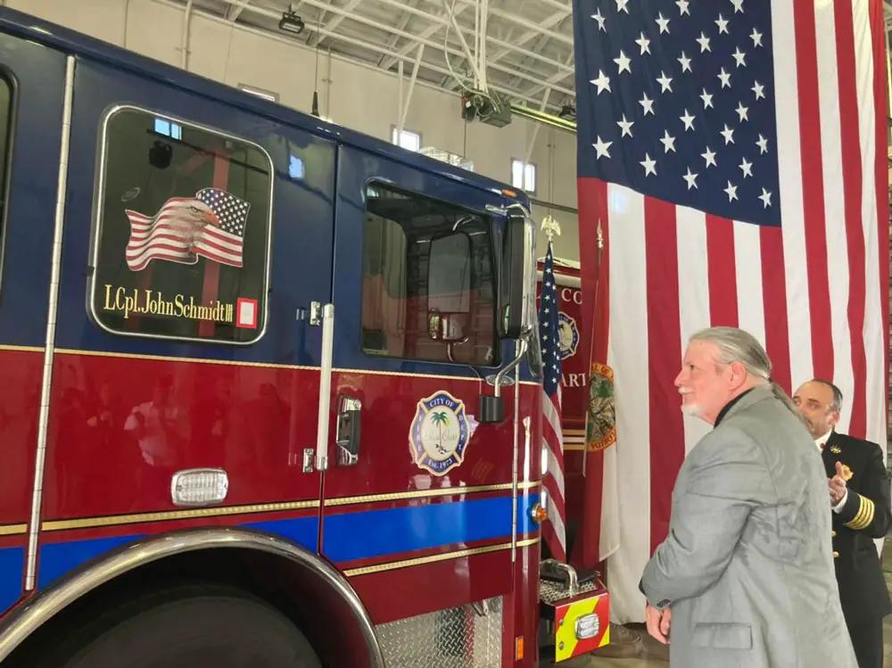 John Schmidt Jr. unveils the name of his son, Marine Lance Corporal John T. Schmidt III on Fire Engine 21