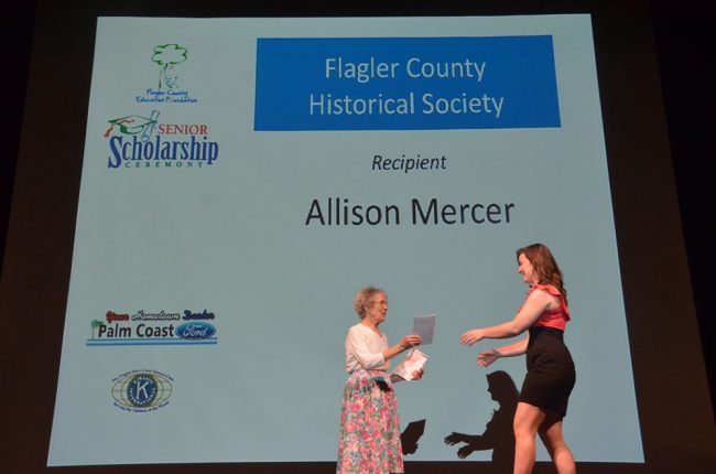 Handing out a scholarship in 2012. (© FlaglerLive)