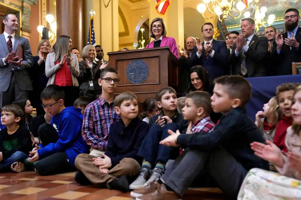 Iowa Gov. Kim Reynolds speaks to supporters before signing a bill that creates education savings accounts in January 2023. 